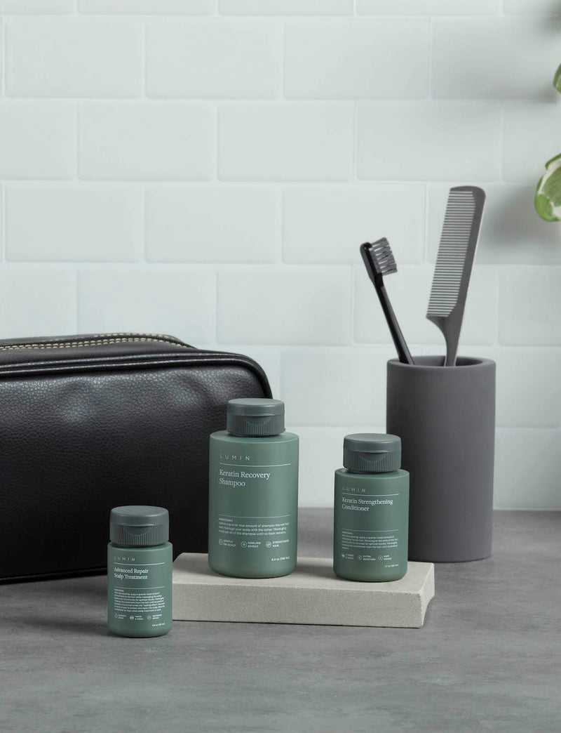 lumin products in a bathroom with comb and washbag in the back